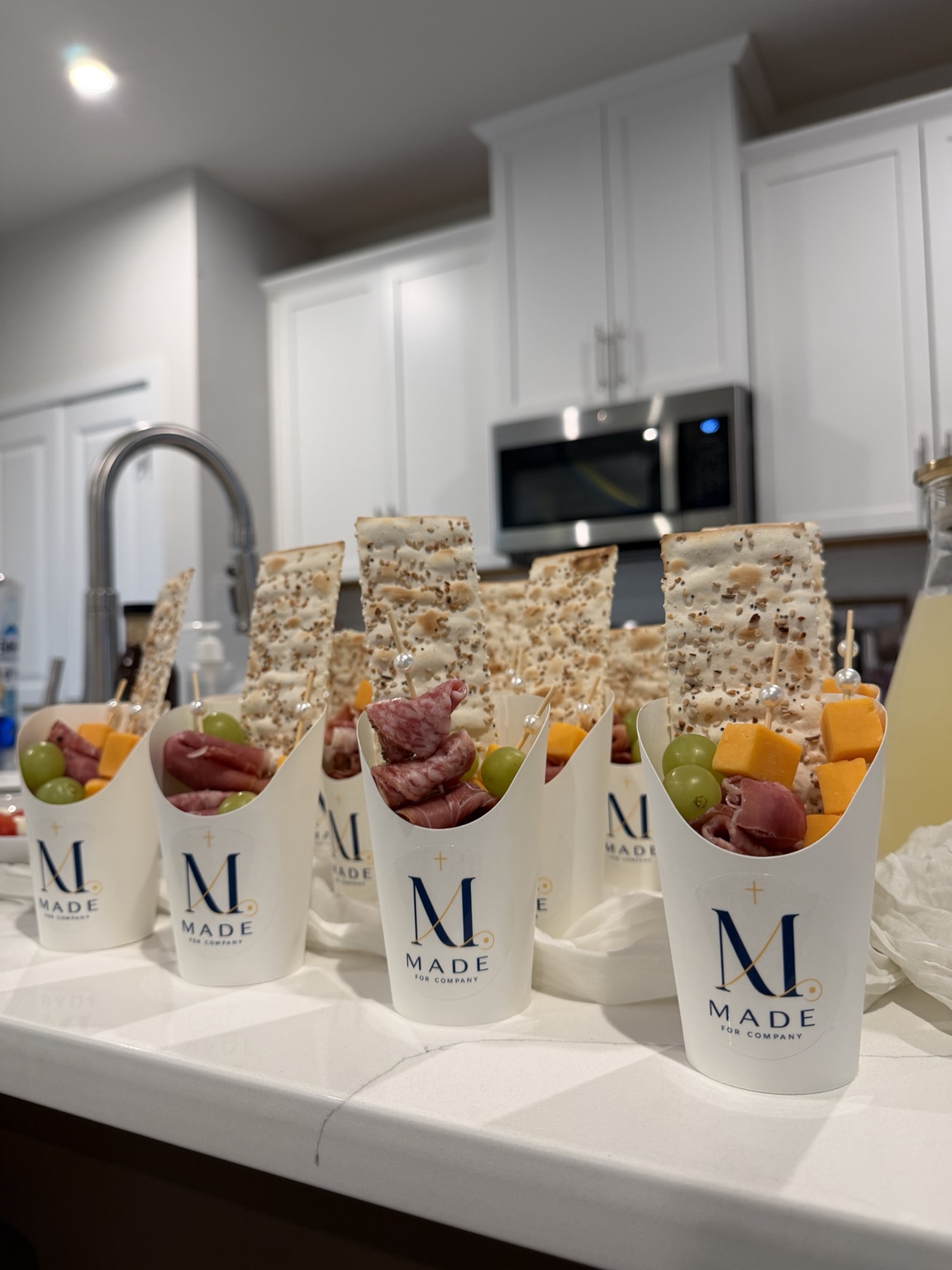 Branded Made for Company charcuterie cups prepared for guests